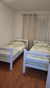 two beds sitting next to each other in a room at Apartman Anita in Livno