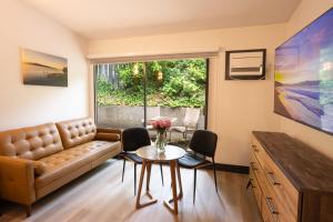 a living room with a couch and a table at Sunshine Lodge Inn in Gibsons