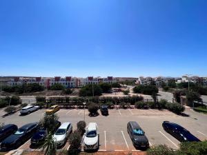 a parking lot with a bunch of cars parked at Luxueuse à Marina Saidia in Saïdia