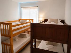two bunk beds in a room with a window at Blue Diamond Suite de playa in Playa Blanca +63 photos