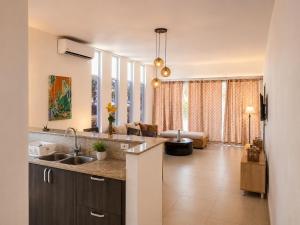 a kitchen with a sink and a living room at Blue Diamond Suite de playa in Playa Blanca