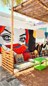 a mural on a wall with a couch and a table at Wanasa house in Dahab