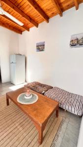 a room with a table and a bed and a refrigerator at Wanasa house in Dahab +16 photos