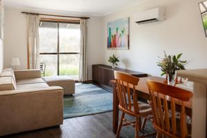 a living room with a table and a couch at Bayview Cabins Kangaroo Island in American River