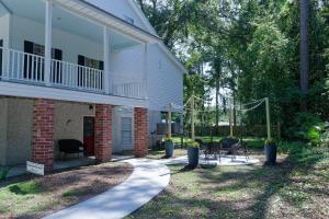 a house with a porch with chairs and a patio at Dolphin Retreat in Brunswick