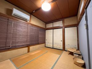 an empty room with a room with a table and windows at Calmbase西伊豆いざよい in Numazu +41 photos