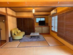 a living room with a couch and a table at Calmbase西伊豆いざよい in Numazu