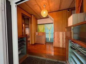 a hallway of a house with wooden walls and wooden floors at Calmbase西伊豆いざよい in Numazu