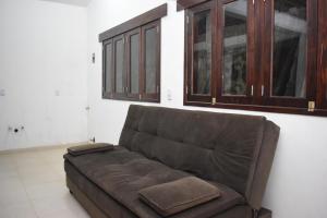 a brown couch in a living room with cabinets at Hotel GUERRERO in Zacatlán +2 photos