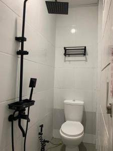a bathroom with a white toilet in a room at Sarasutha hotel and pool in Lembuak +41 photos