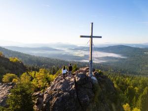 a couple standing on top of a cross on a mountain at Landal Arber in Zwiesel