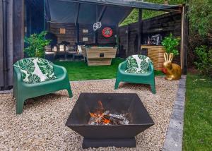 two chairs and a fire pit in a backyard at Oakwood Lodges in Skipwith