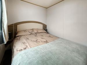a small bedroom with a bed in a room at Kjs Holiday Haven in Ayr +9 photos