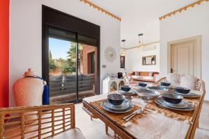 a dining room with a table with dishes on it at Villa des Roses in Marrakesh