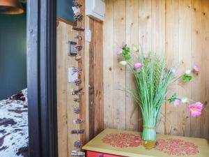 a vase sitting on a table with flowers in it at The Peacock Roost - Uk46297 in Brynkir +3 photos