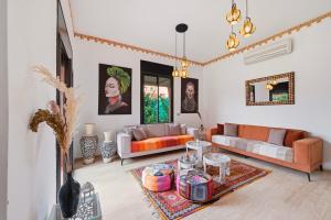 a living room with a couch and a table at Villa des Roses in Marrakesh