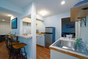 a kitchen with a stainless steel sink and a counter at Dolphin Retreat in Brunswick