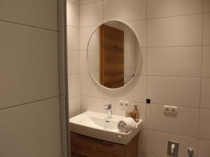 a bathroom with a sink and a mirror at Modern apartment in the Tyrolean mountains in Fliess +43 photos