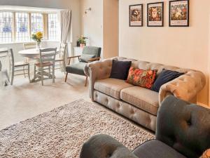 a living room with a couch and a table at Causeway Cottage in Wolsingham