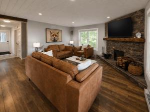 a living room with a couch and a fireplace at Riverside Retreat in Rexton