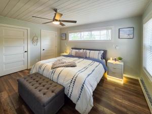a bedroom with a large bed and a ceiling fan at Riverside Retreat in Rexton