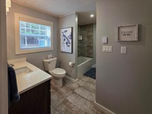 a bathroom with a toilet and a sink and a shower at Riverside Retreat in Rexton +39 photos