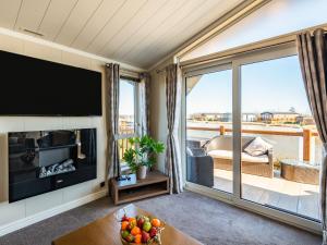 a living room with a large flat screen tv at Buff Lake - Uk37725 in Ingoldmells