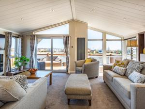 a living room with a couch and a table at Buff Lake - Uk37725 in Ingoldmells +21 photos