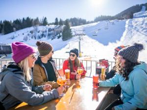 a group of people sitting at a table with drinks at Landal Brandnertal in Bürserberg
