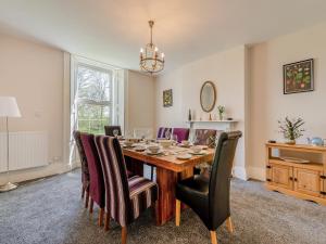 a dining room with a wooden table and chairs at Monkroyd House in Purston Jaglin
