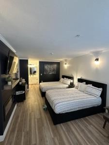 a bedroom with two beds and a flat screen tv at Legends Fountain View Ground Floor Studio Unit 109 in Bellaire +28 photos