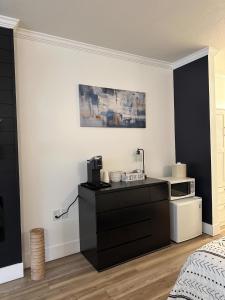 a bedroom with a black dresser and a bed at Legends Fountain View Ground Floor Studio Unit 109 in Bellaire