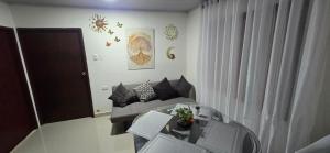 a living room with a couch and a glass table at Cerete Apartment 111 in Cereté