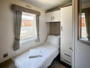 a small bedroom with a bed and a window at Dorado Cottage - Uk49469 in Morpeth +4 photos
