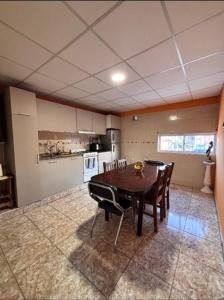 a kitchen with a table and chairs in a room at Aires de Mendoza in Maipú