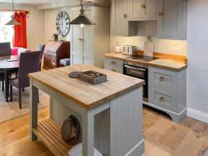 a kitchen with a island in the middle of a room at St Anthonys in Ampleforth +12 photos