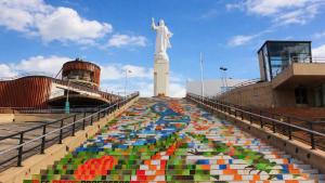 a large mural of a statue in front of a monument at Hotel Lord by Croma in Cúcuta