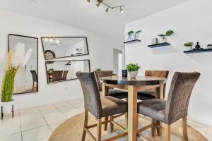 a dining room with a table and chairs at New Casa Eva Turfed Pool 5Br in Hallandale Beach
