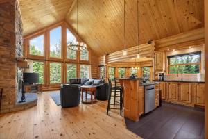 a kitchen and living room in a log cabin at Fiddler Lake Resort - Rabbit 57 in Mille-Isles
