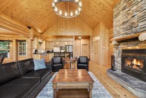 a living room with a couch and a fireplace at Fiddler Lake Resort - Rabbit 57 in Mille-Isles