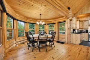 a dining room with a table and chairs at Fiddler Lake Resort - Rabbit 57 in Mille-Isles