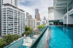 a swimming pool on top of a building with a city at MyRehat Suites Bukit Ceylon in Kuala Lumpur