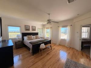 a bedroom with a bed and a ceiling fan at The Gathering Place home in Montrose