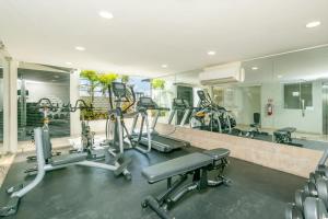 a gym with treadmills and cardio equipment in a room at 2Br Condo W Rooftop Pool & Backyard in Playa del Carmen