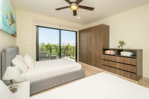 a bedroom with a bed and a ceiling fan at 2Br Condo W Rooftop Pool & Backyard in Playa del Carmen