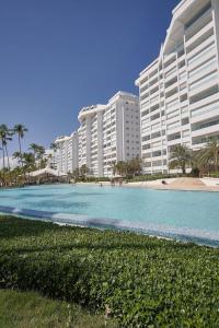 a view of a beach with buildings in the background at Marbellaluxessence Beachfrontpool11Thfloor in Villas del Mar