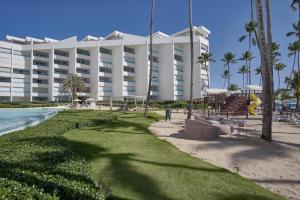 a large hotel with a playground in front of a resort at Marbellaluxessence Beachfrontpool11Thfloor in Villas del Mar