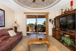 a living room with a couch and a tv at Sandy Beach Rocky Point Bella Sirena 203-E in Puerto Peñasco