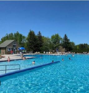 a large swimming pool with people in the water at The Emerald Cabin in Tobyhanna