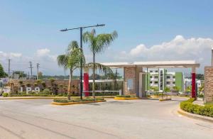 a gas station with palm trees in a parking lot at The-Comfty-Spot Experience Sd Wifi in Santo Domingo